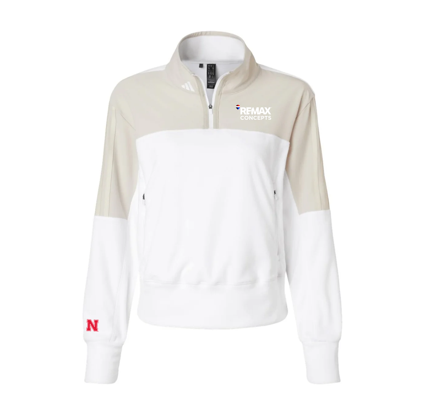 A women's colorblock quarter-zip sweatshirt by adidas, featuring a white body, beige upper chest and sleeves, a white lower sleeve, and a red Nebraska 'N' logo on the left cuff. The right chest features a white 'REMAX CONCEPTS' logo.