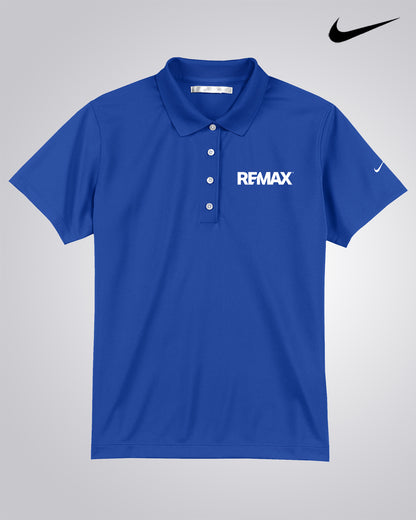 A royal blue short-sleeve polo shirt with 'REMAX' printed in white on the chest and a white Nike swoosh on the sleeve, displayed on a light gray gradient background with a black Nike swoosh logo in the top right corner.