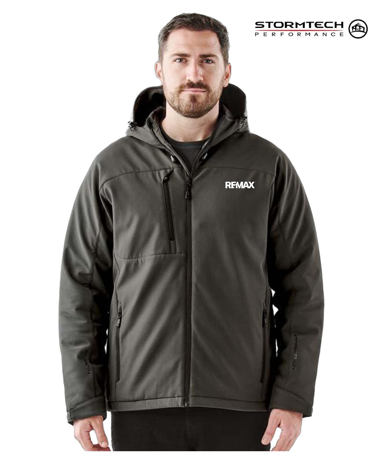 Man wearing a black jacket with REMAX logo on a white background, featuring Stormtech branding.