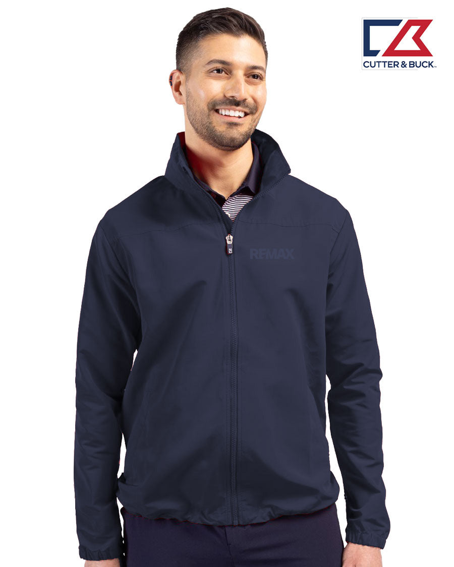 Man wearing a navy jacket with a visible brand logo on a white background