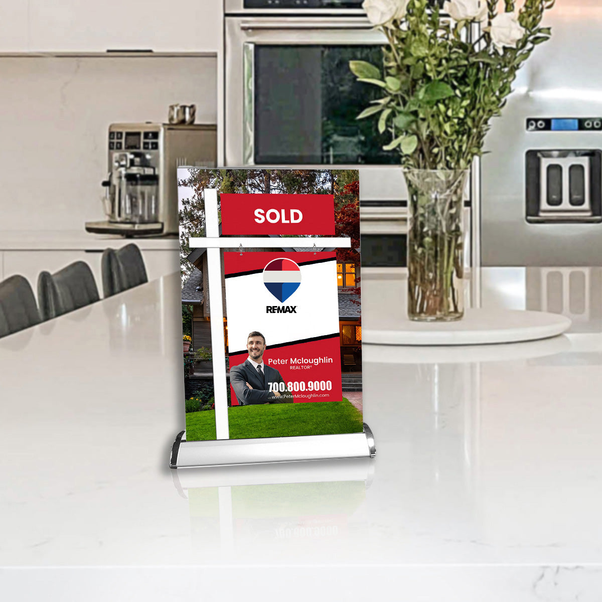 Real estate sign with Remax logo on a kitchen counter