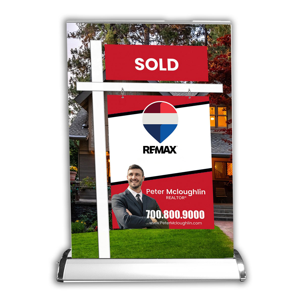 Real estate roll-up banner with REMAX logo and contact information in front of a house.