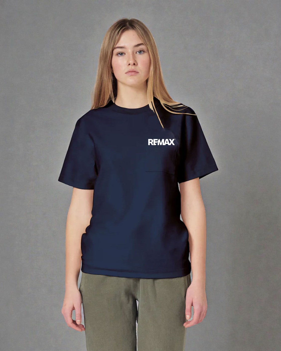 A woman modeling a navy blue short-sleeve t-shirt with a white 'REMAX' logo on the chest, paired with olive green pants, against a neutral gray background.