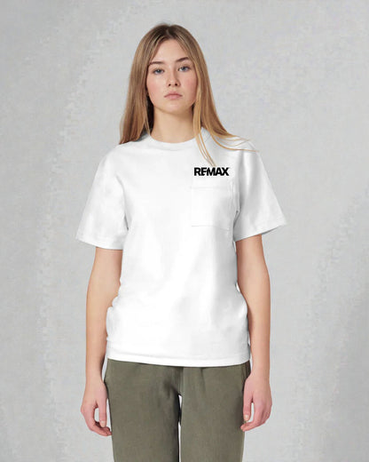 A woman modeling a white short-sleeve crewneck pocket t-shirt with a black 'REMAX' logo printed on the chest, paired with olive green pants, against a textured gray studio background.