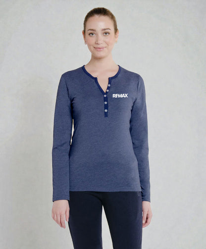 A woman modeling a heathered navy blue long-sleeve henley top with a white REMAX logo on the chest, paired with dark pants, against a textured light gray background.