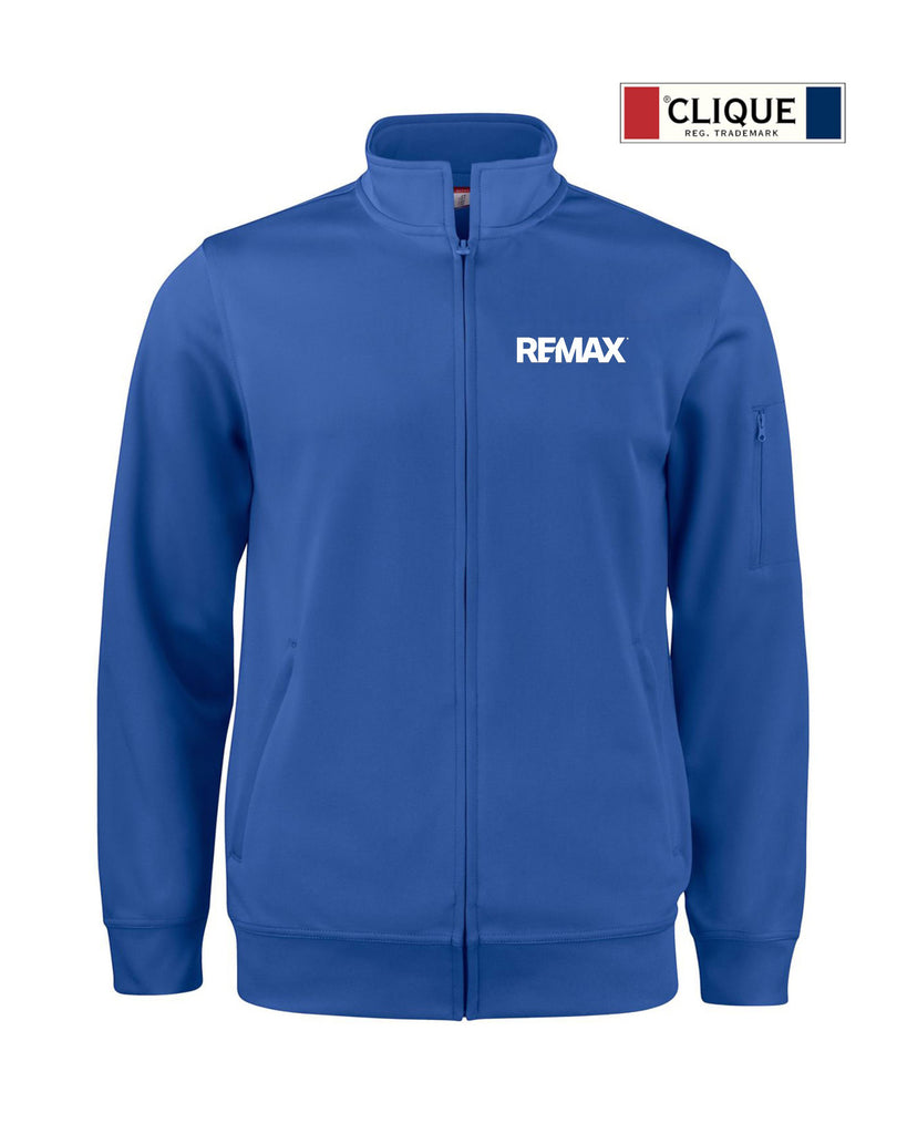 A royal blue zip-up track jacket with a stand collar, featuring the white 'REMAX' logo on the left chest. The jacket is displayed on a clean white background with a 'CLIQUE DES TRAVAUX' logo badge in the top right corner.