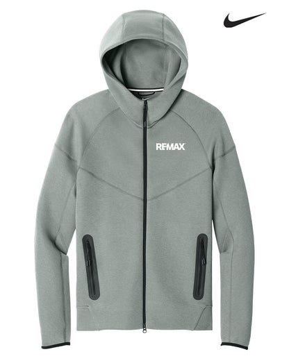 A light gray Nike REMAX full-zip hoodie with a white logo on the chest, displayed on a clean white background with a black Nike swoosh in the top right corner.