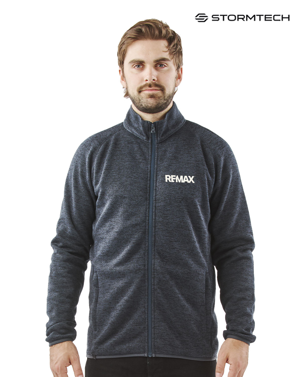 Man wearing a gray jacket with REMAX logo on a white background, featuring Stormtech branding.