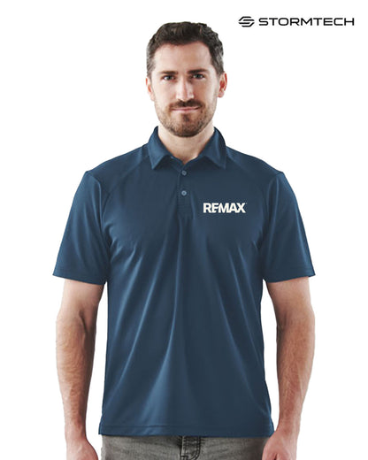 Man wearing a blue polo shirt with REMAX logo on a white background