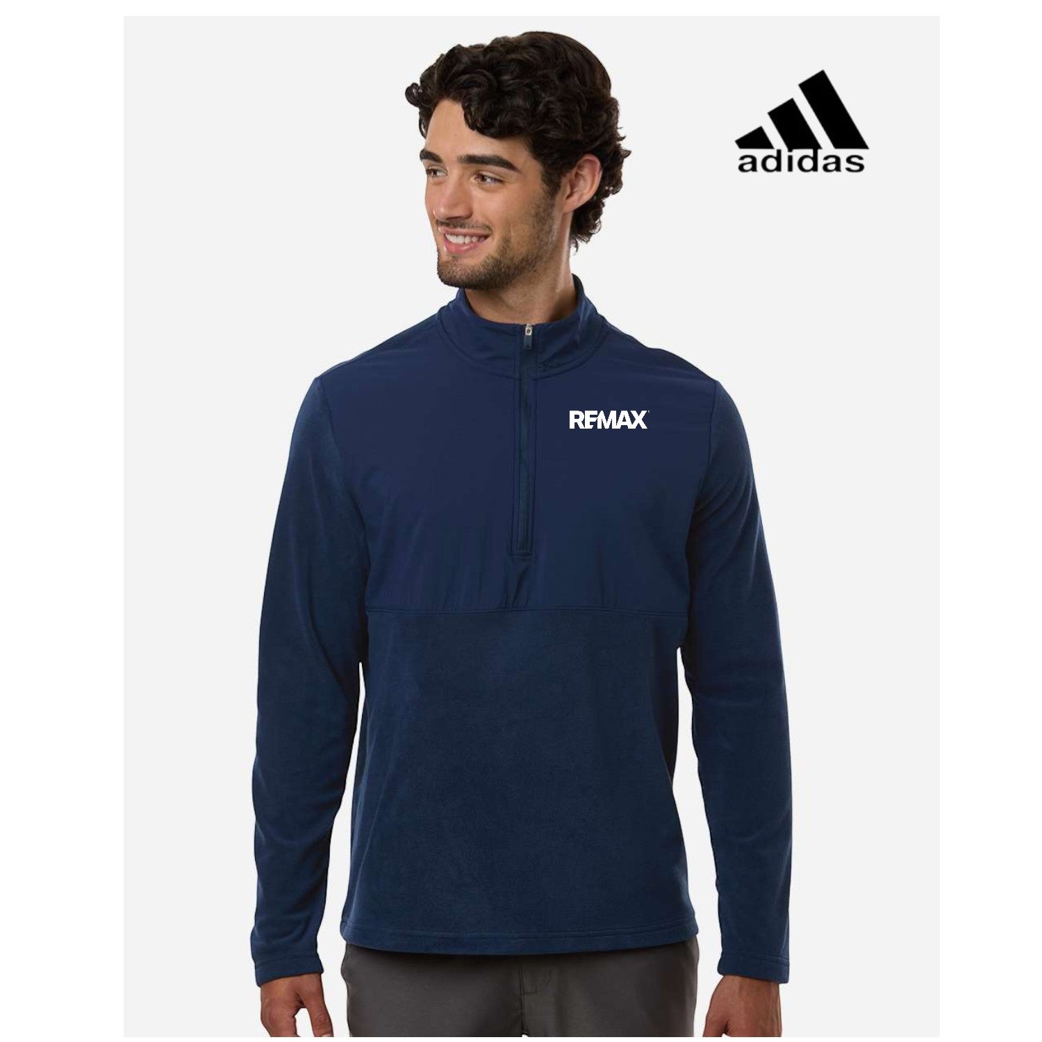 Man wearing a navy blue Adidas jacket with a visible Remax logo on a white background