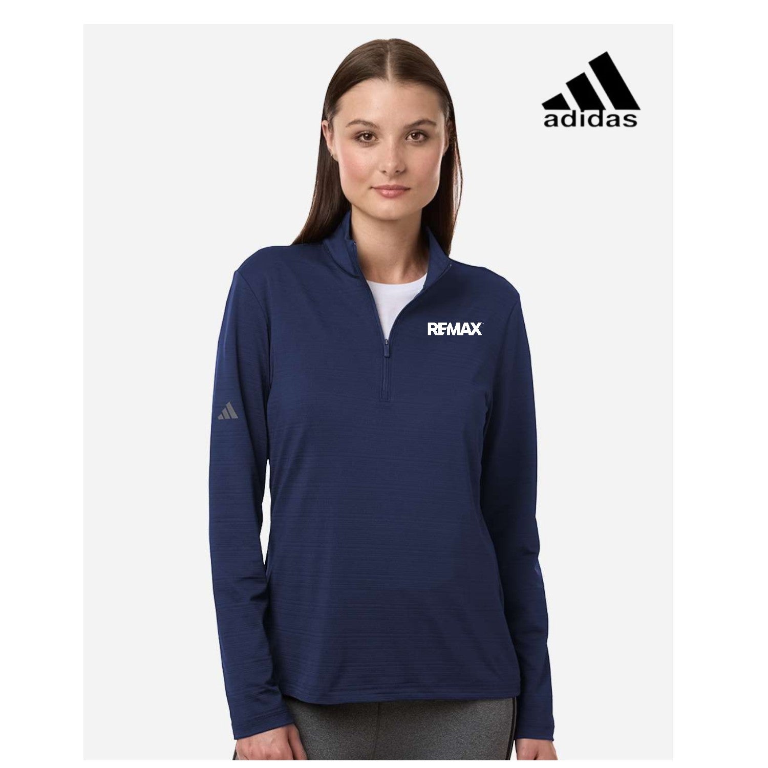 Woman wearing a navy blue Adidas jacket with 'REMAX' branding on a white background