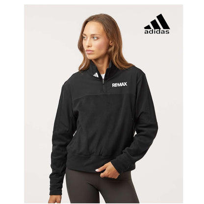 Woman wearing a black Adidas jacket with Remax logo on a white background
