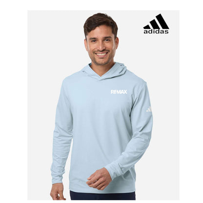 Man wearing a light blue hoodie with Adidas and Remax logos on a white background