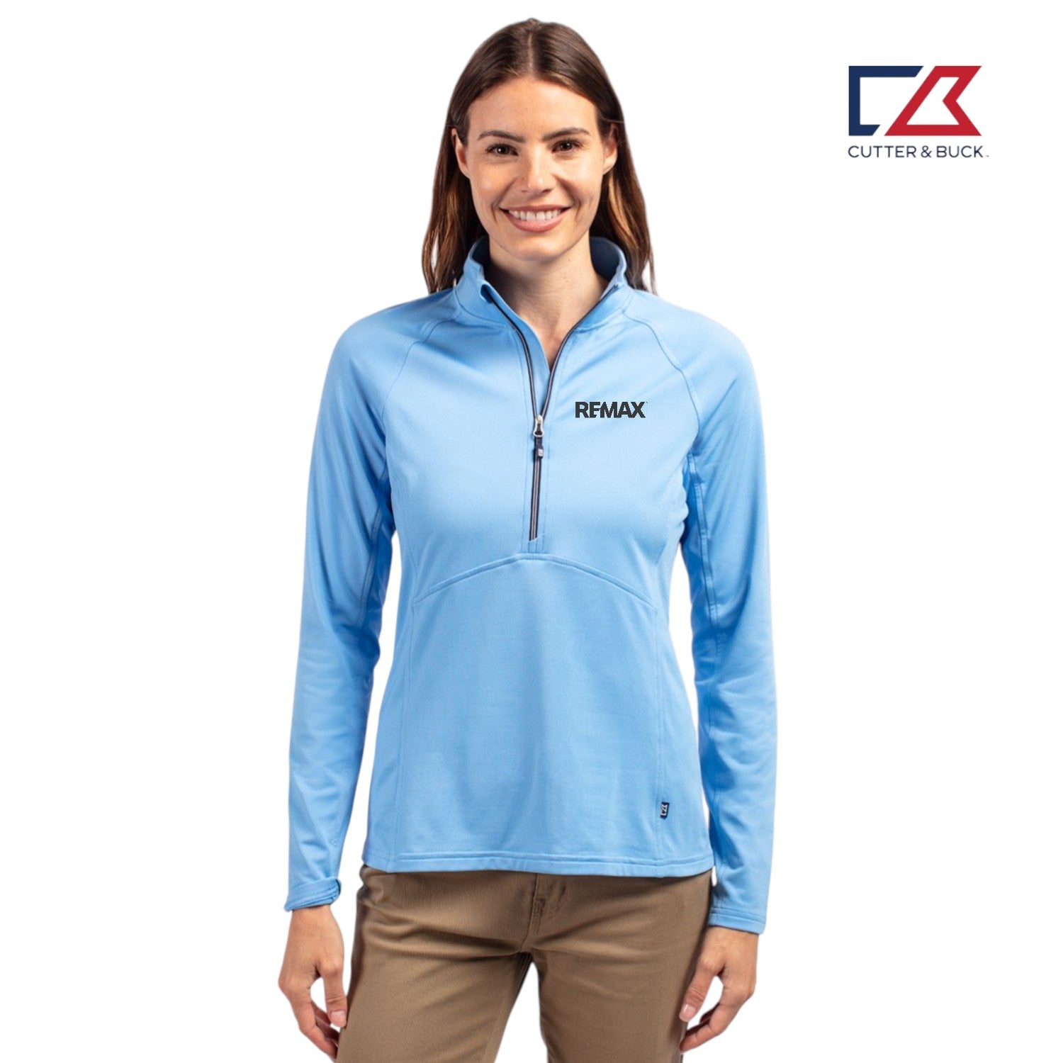 Woman wearing a blue long-sleeve shirt with a visible brand logo on a white background