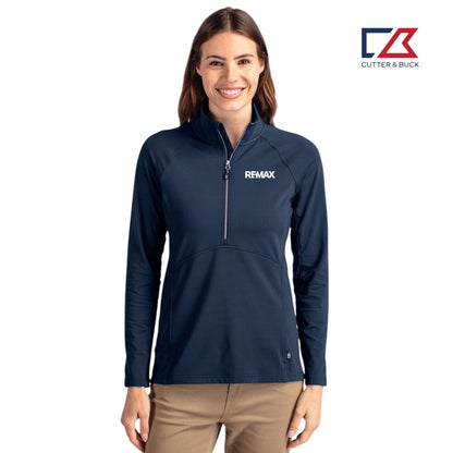 Woman wearing a navy blue pullover with a logo on a white background