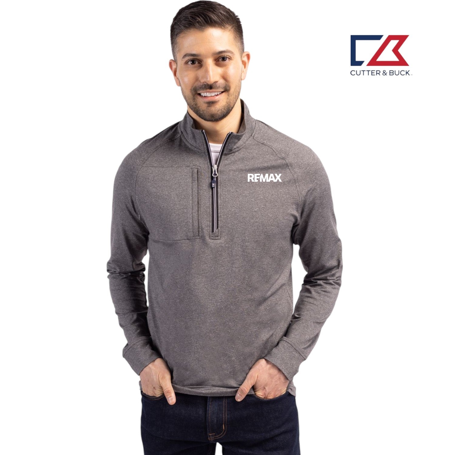 Man wearing a gray pullover with 'REMAX' logo, standing against a white background with Cutter & Buck logo.