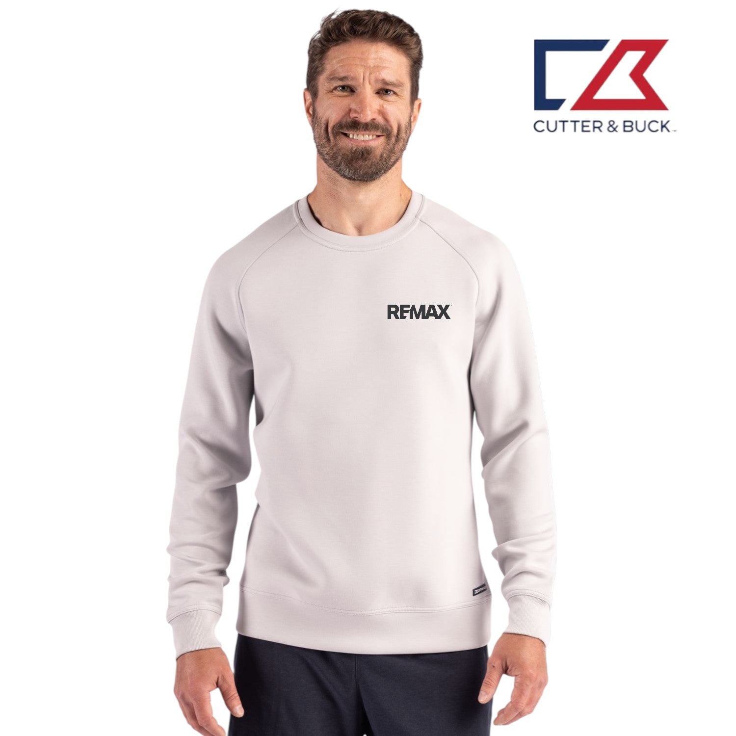 Man wearing a light gray sweatshirt with 'REMAX' logo and 'Cutter & Buck' branding on a white background