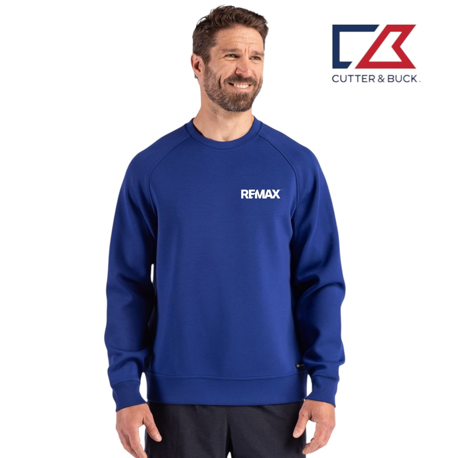 Man wearing a blue sweatshirt with 'REMAX' logo, standing against a white background with Cutter & Buck logo.