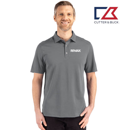 Man wearing a gray polo shirt with a logo on a white background, featuring the Cutter & Buck brand.
