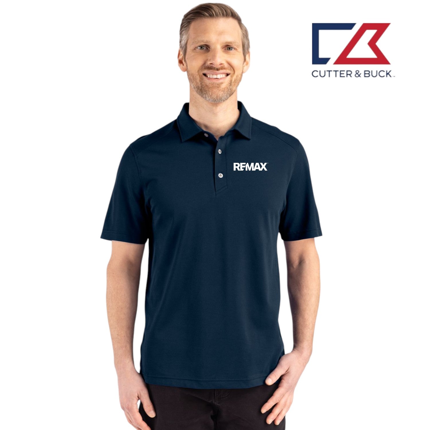 Man wearing a navy blue polo shirt with a logo on a white background, featuring the Cutter & Buck and RE/MAX logos.