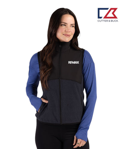 Woman wearing a black and blue vest with Remax logo on a white background