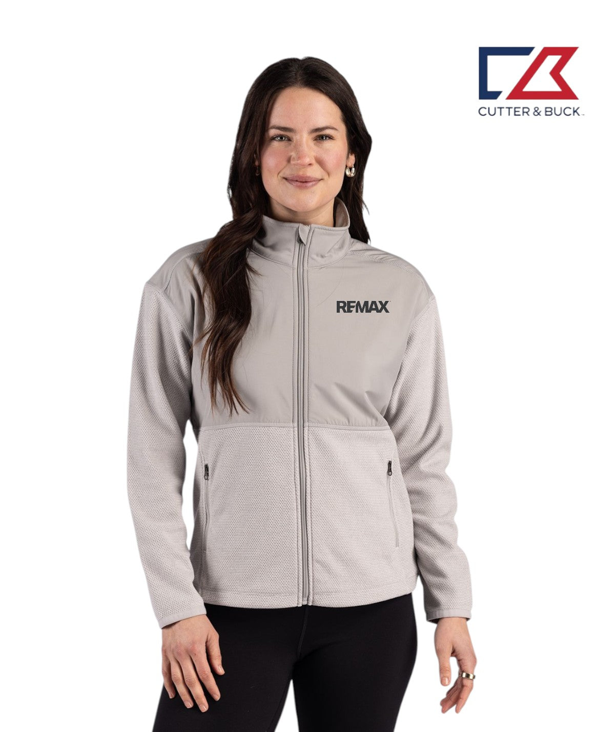 Woman wearing a gray jacket with REMAX logo on a white background, featuring Cutter & Buck logo.