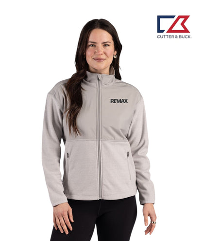 Woman wearing a gray jacket with REMAX logo on a white background, featuring Cutter & Buck logo.