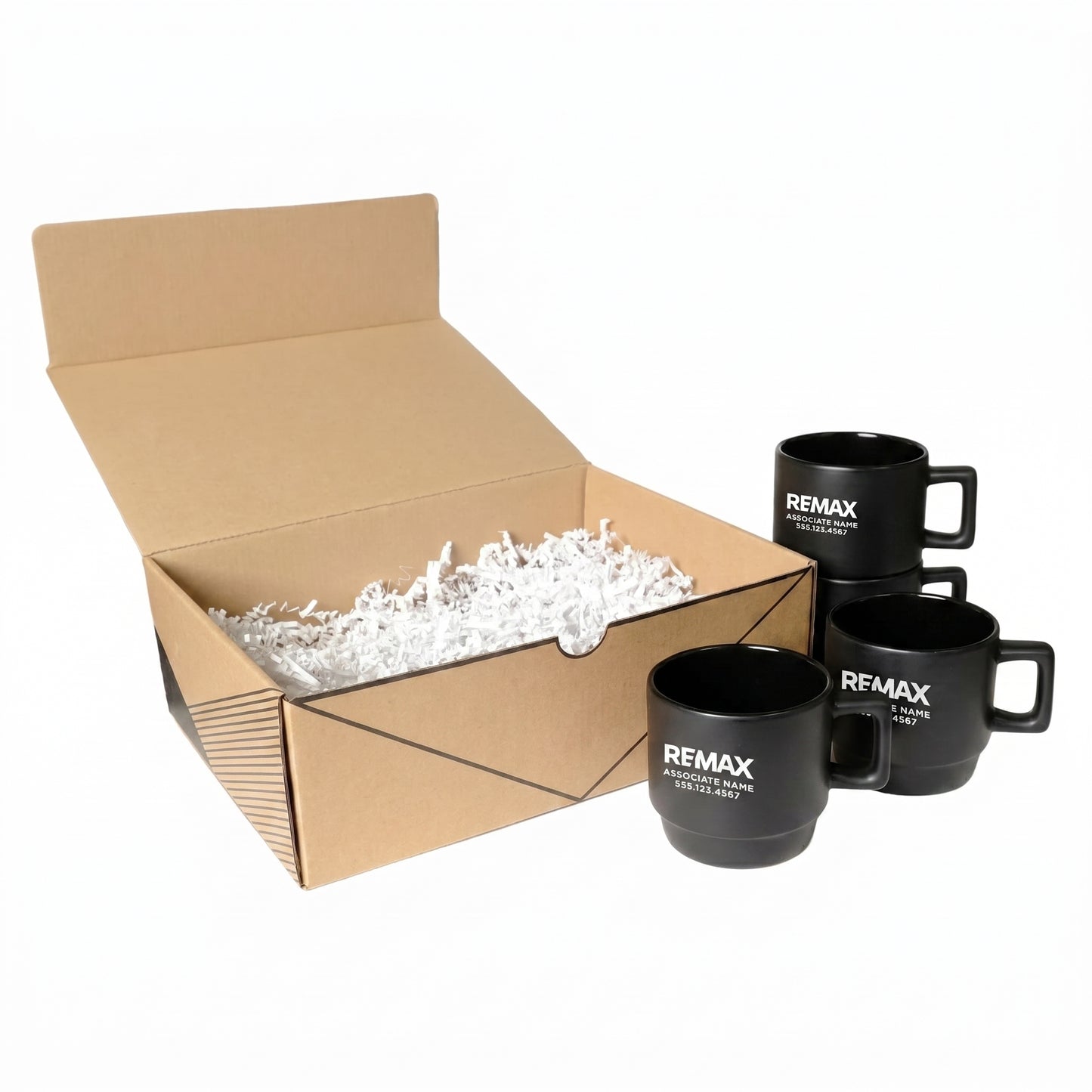 Black mugs with REMAX branding in front of an open cardboard box filled with packing peanuts.
