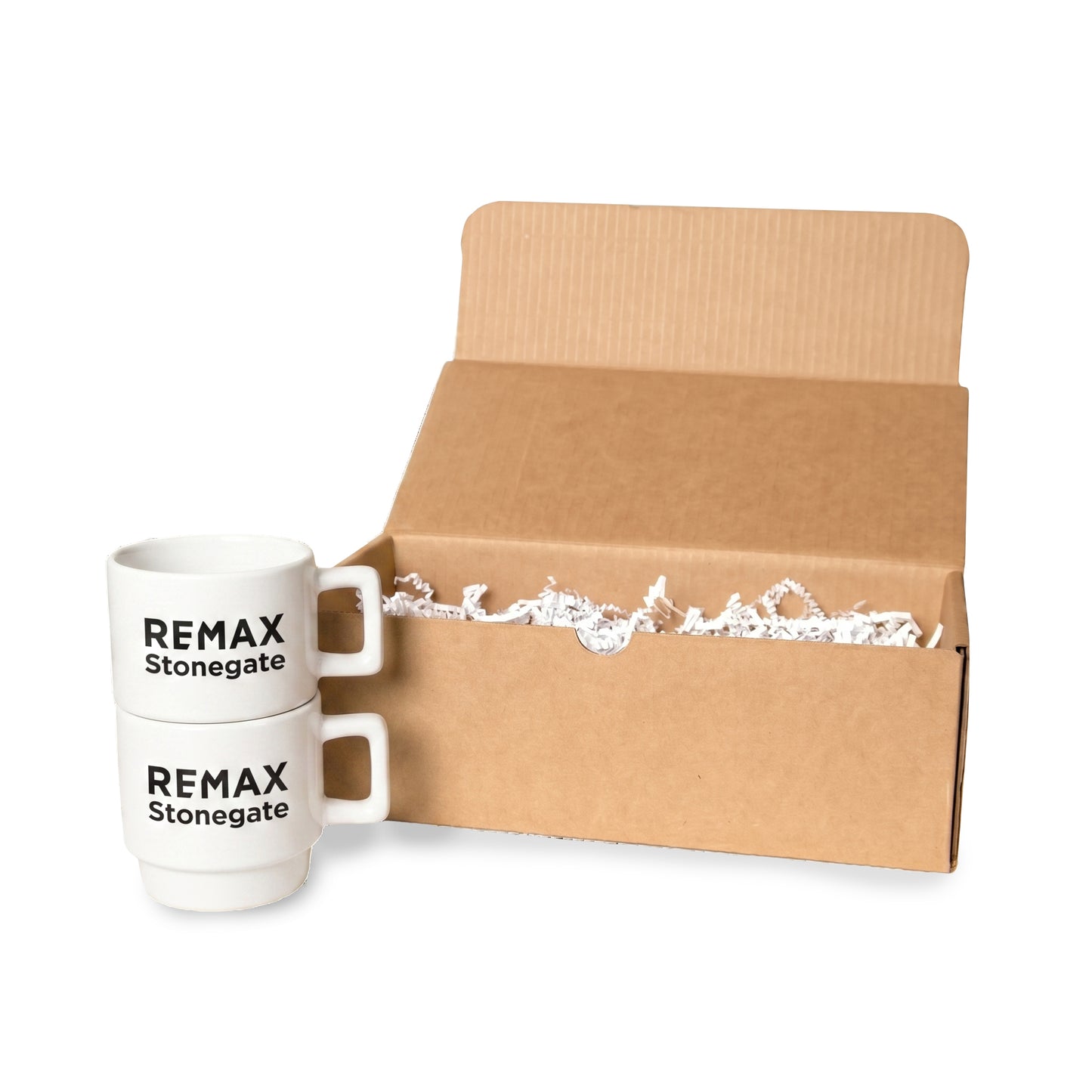 Two white mugs with 'REMAX Stonegate' branding next to an open cardboard box.