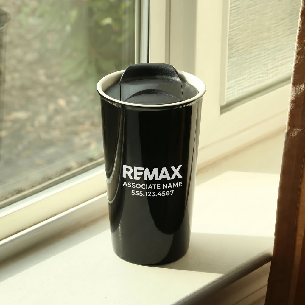 Black tumbler with REMAX branding on a windowsill