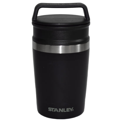 Black Stanley insulated mug with a silver rim on a white background