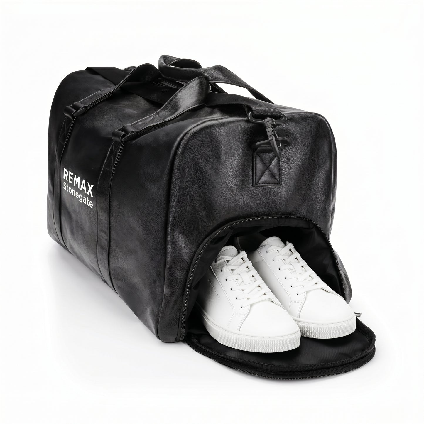 Black leather duffle bag with straps and a REMAX Stonegate logo with white shoes.