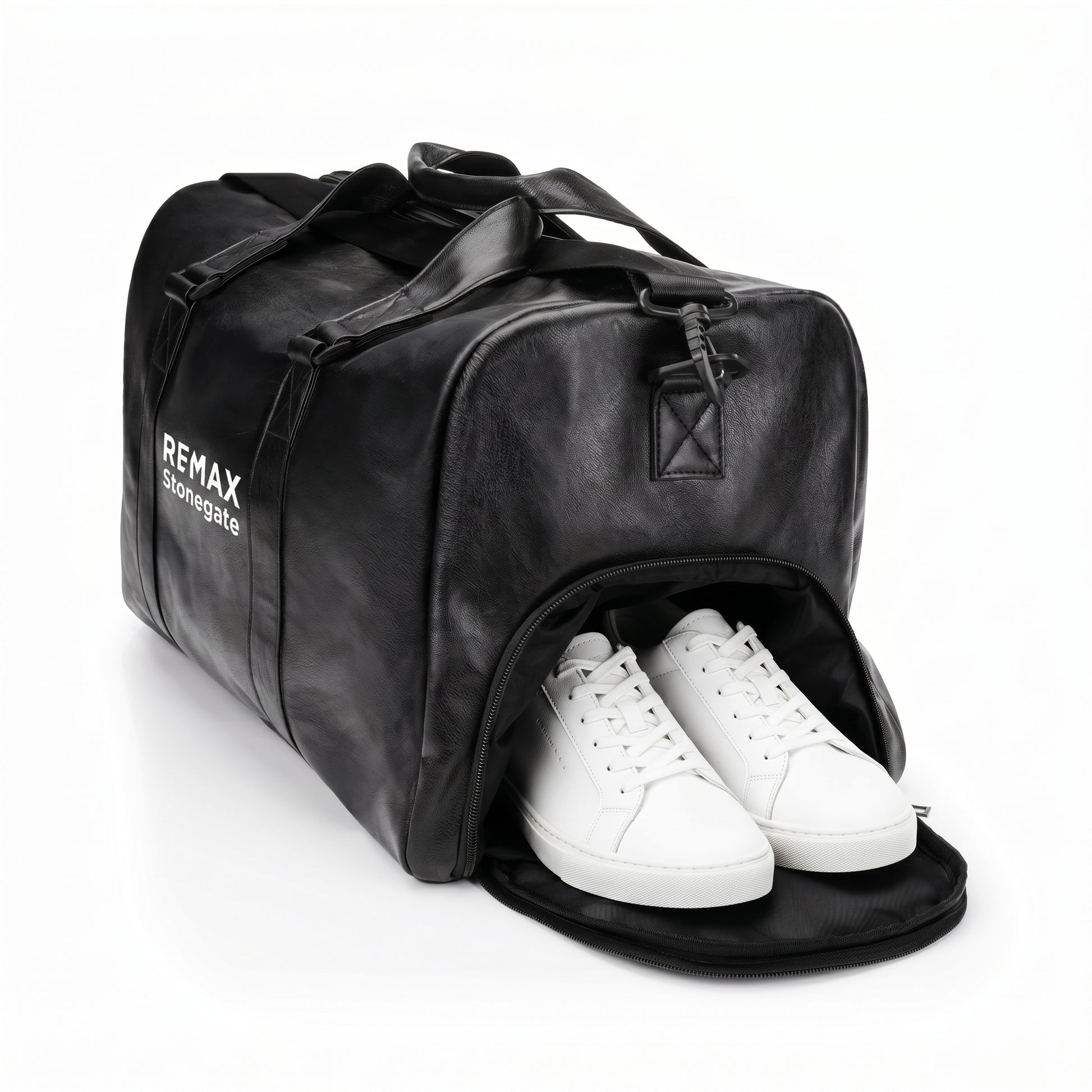 Black leather duffle bag with straps and a REMAX Stonegate logo with white shoes.