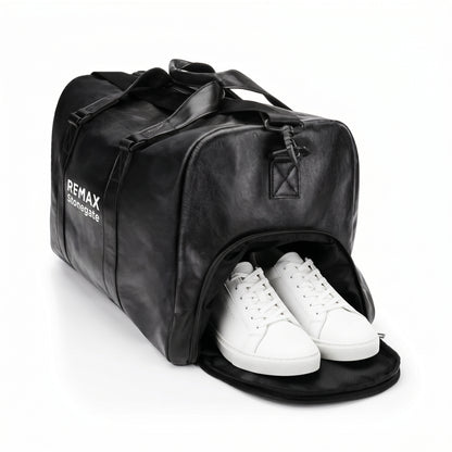 Black leather duffle bag with straps and a REMAX Stonegate logo with white shoes.