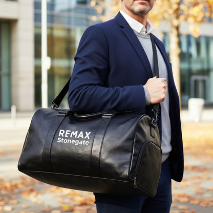 Black leather duffle bag with straps and a REMAX Stonegate logo