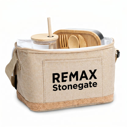 Beige cooler bag with REMAX Stonegate branding containing wooden cutlery and a straw.