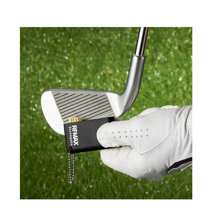 Golf club with a Remax storage device attached, held by a gloved hand on a grass background