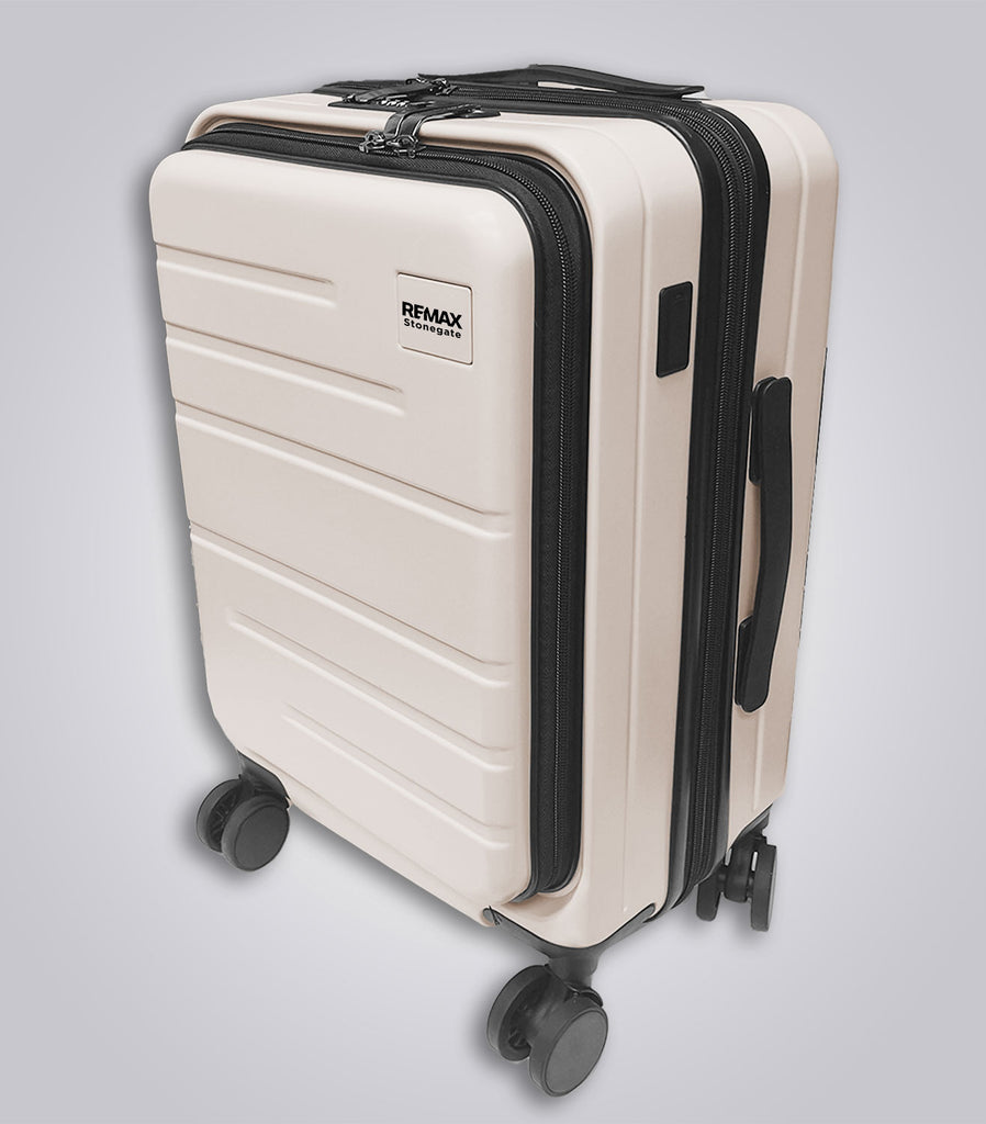 Beige suitcase with black handles and wheels on a light gray background