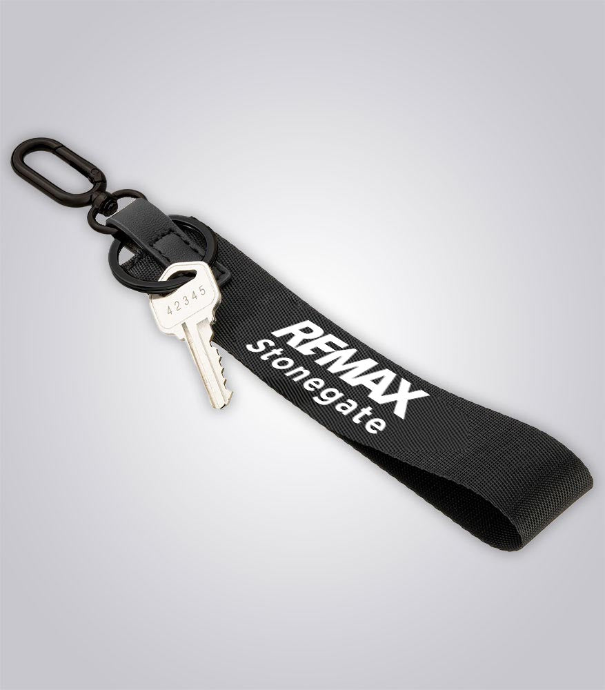 Black keychain with a key and 'REMAX Stonegate' branding on a light gray background