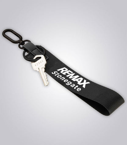 Black keychain with a key and 'REMAX Stonegate' branding on a light gray background
