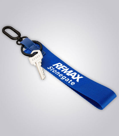 Blue keychain with a key and 'REMAX Stonegate' branding on a light gray background