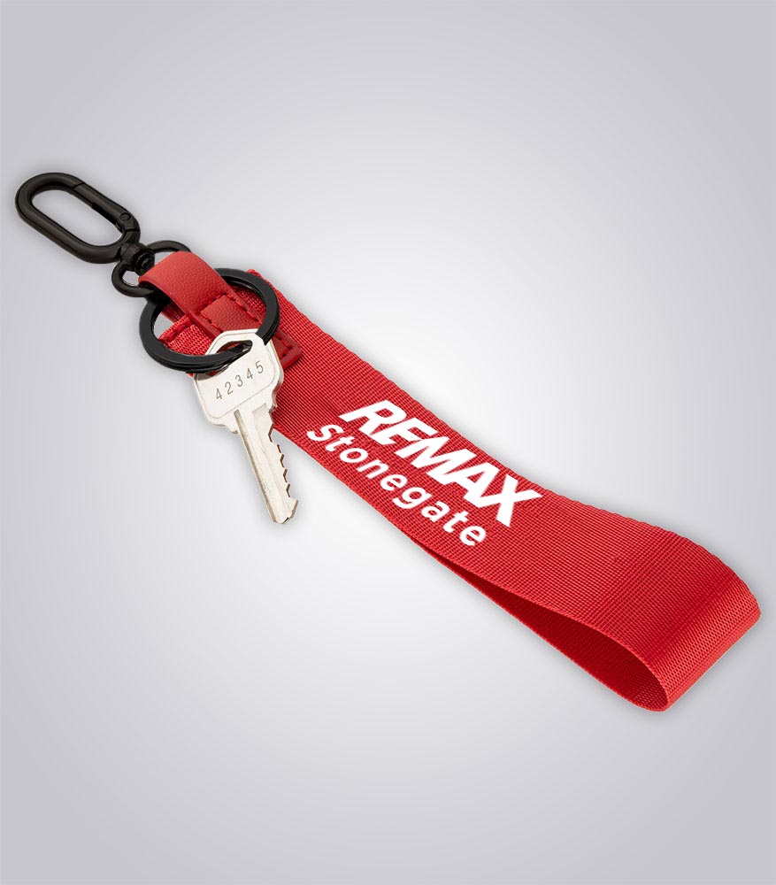 Red keychain with a key and 'REMAX Stonegate' branding on a light gray background