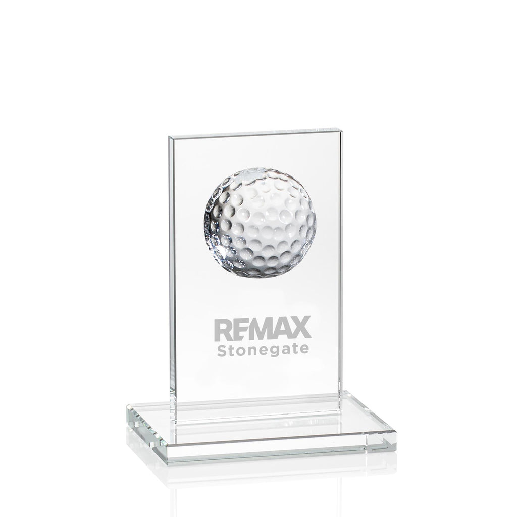 Glass award with golf ball and engraved text on a white background