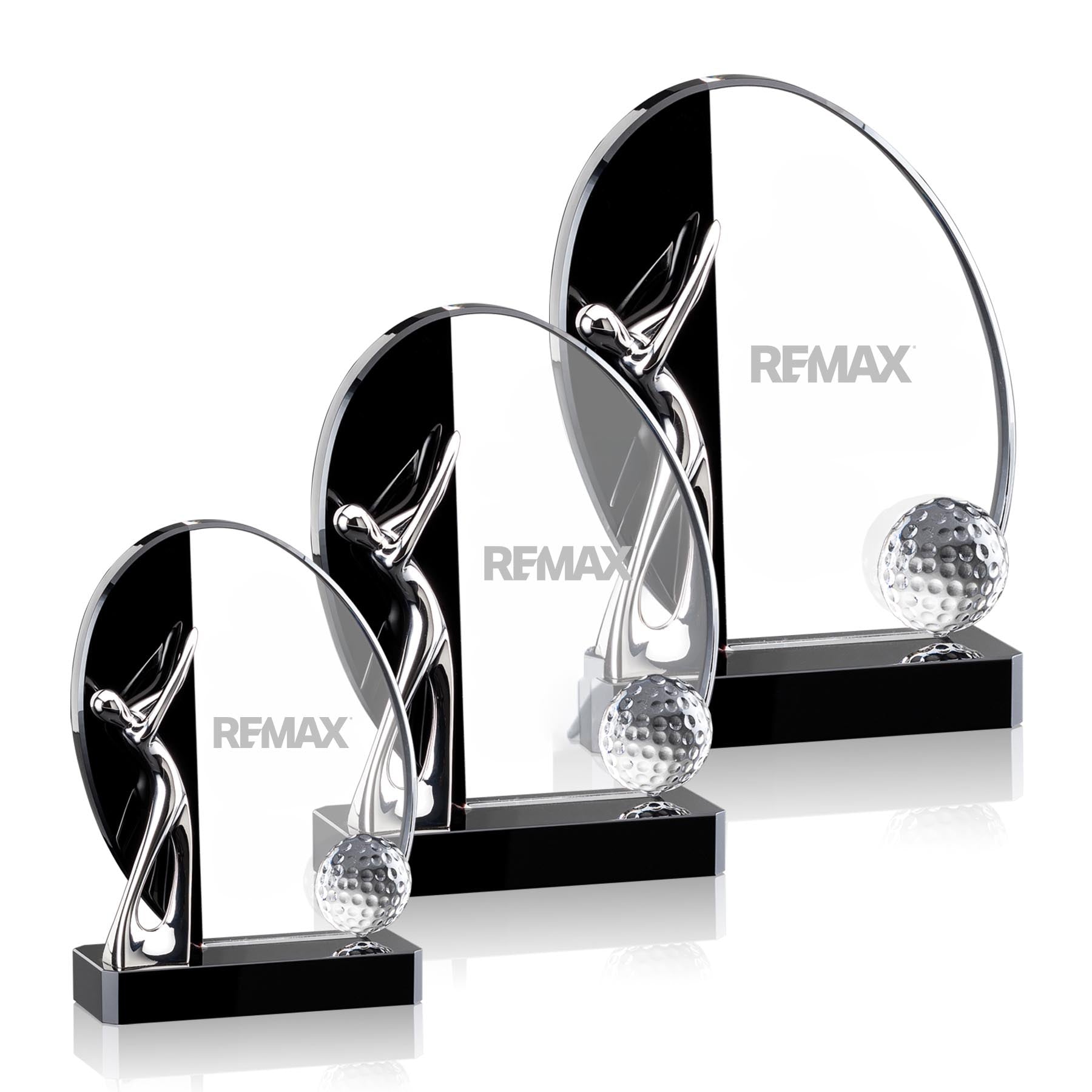 Set of crystal golf trophies with REMAX branding on a white background