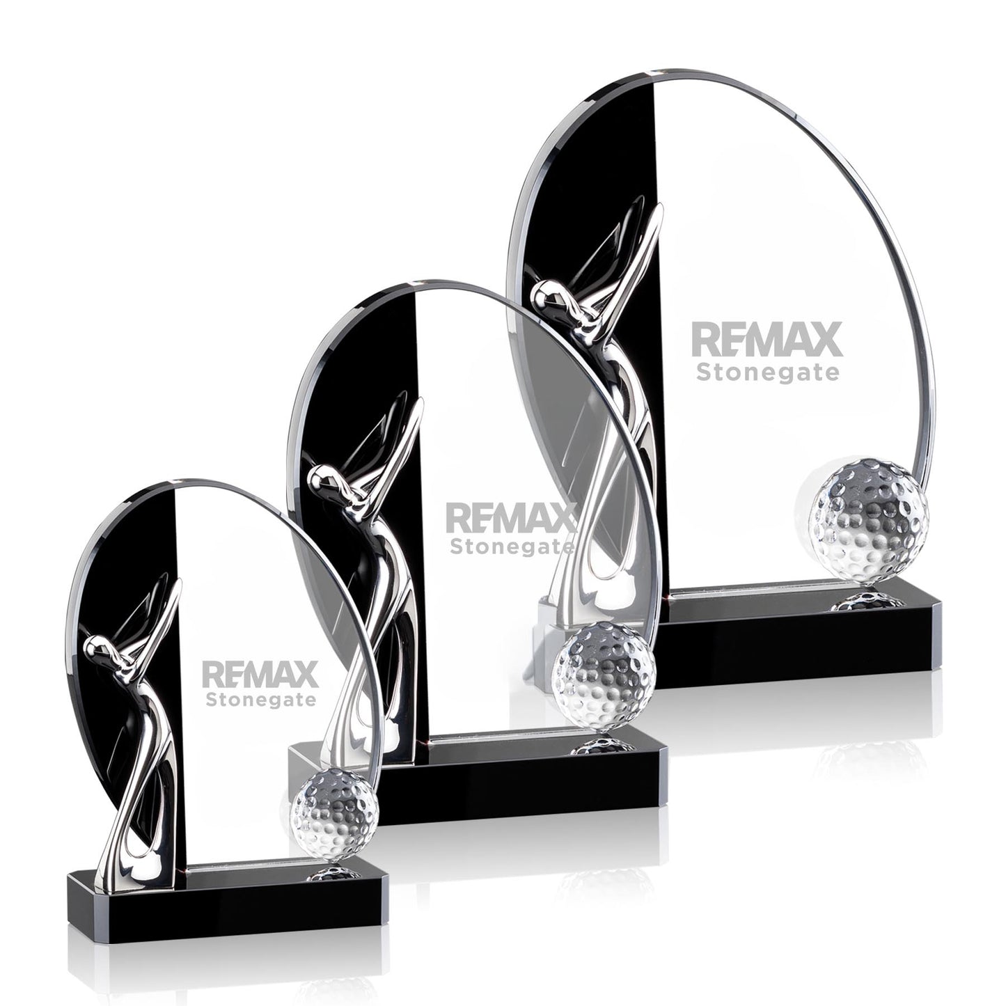 Set of crystal golf trophies with REMAX branding on a white background