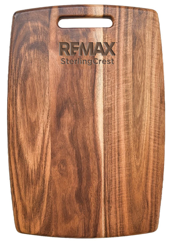 Wooden cutting board with REMAX Sterling Crest branding on a white background
