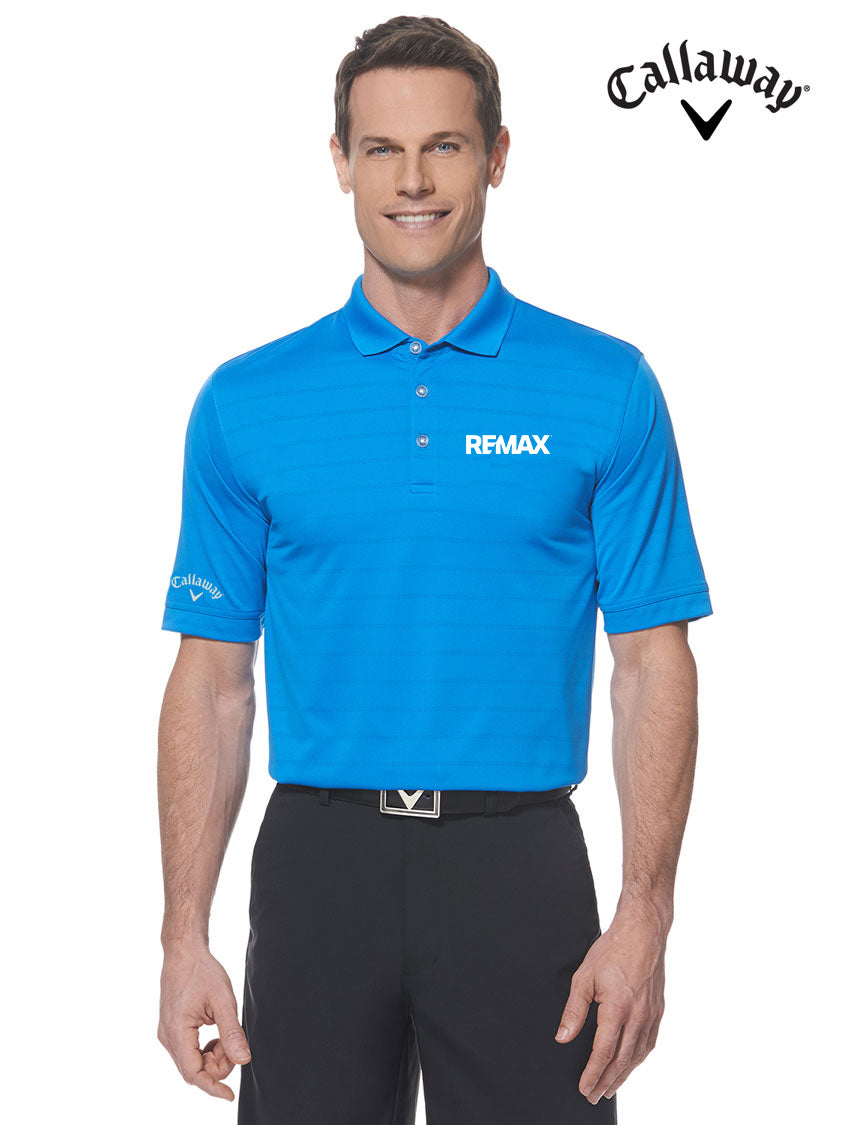 A man modeling a bright blue Callaway RFMAX short-sleeve polo shirt with white logos, paired with black pants, against a plain white background. The Callaway logo is also shown in the top right corner.