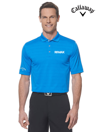 A man modeling a bright blue Callaway RFMAX short-sleeve polo shirt with white logos, paired with black pants, against a plain white background. The Callaway logo is also shown in the top right corner.