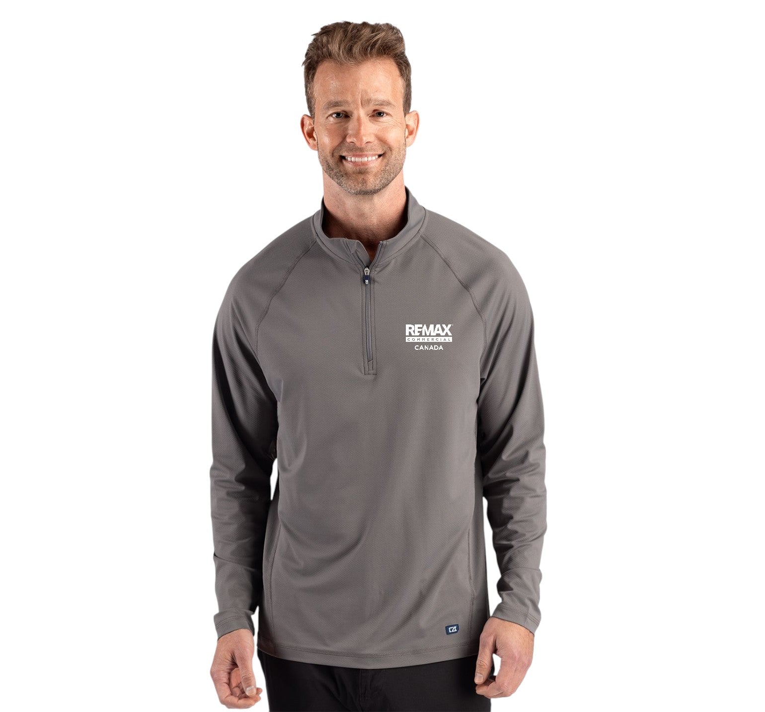 A man wearing a gray long-sleeve quarter-zip pullover with a white 'REMAX' logo on the left chest, photographed against a plain white background.