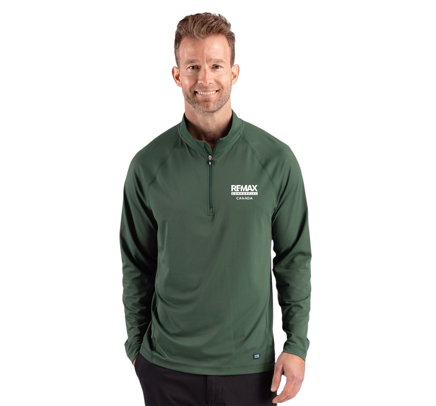 A man wearing a dark green long-sleeve quarter-zip pullover with a white 'REMAX' logo on the left chest, photographed against a solid white background.